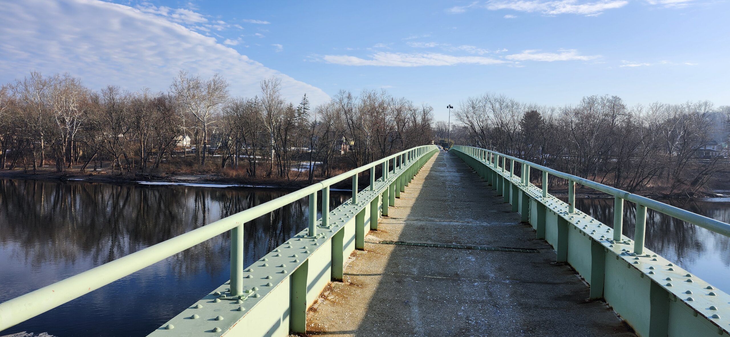 Pedestrian bridge leading forward over water symbolizing a clear path toward building an online business.